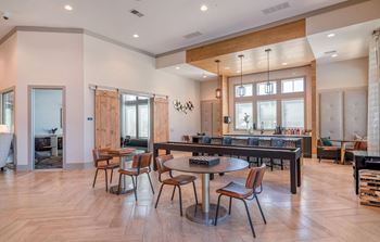 A dining room with a table and chairs